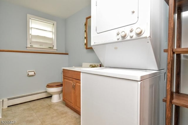 washroom featuring laundry area, light tile patterned floors, stacked washer and clothes dryer, and baseboard heating