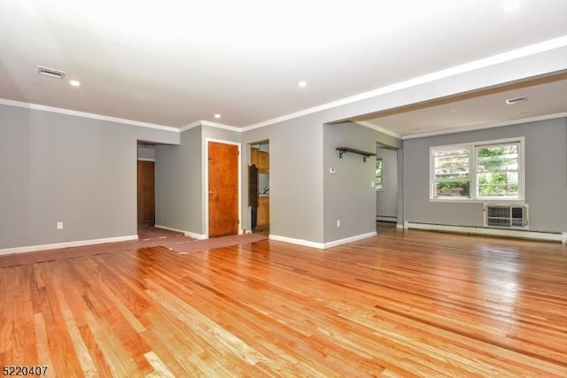 interior space featuring visible vents, crown molding, a baseboard heating unit, baseboards, and light wood-style floors