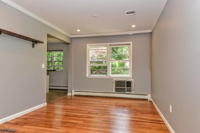 unfurnished room with visible vents, light wood-style flooring, crown molding, baseboards, and baseboard heating