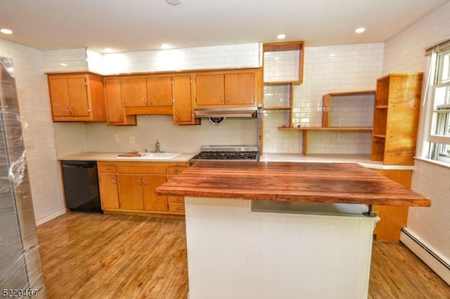 kitchen featuring a sink, under cabinet range hood, black dishwasher, light wood-style floors, and baseboard heating