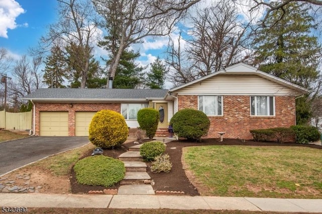 ranch-style house featuring aphalt driveway, a garage, fence, and brick siding