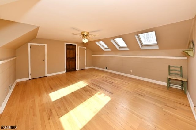 bonus room with vaulted ceiling, baseboards, and wood finished floors