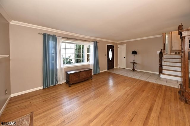 entrance foyer with crown molding, stairway, baseboards, and light wood-type flooring