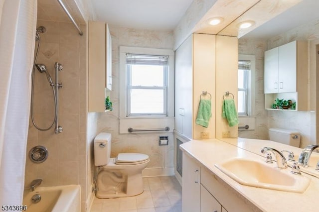 full bathroom with toilet, shower / tub combo, tile patterned flooring, baseboards, and vanity