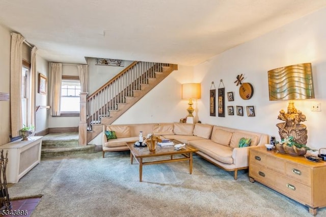 carpeted living area with stairway