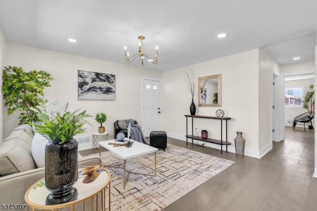 living room featuring recessed lighting, baseboards, an inviting chandelier, and wood finished floors