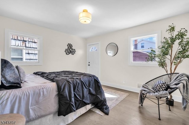 bedroom with baseboards and wood finished floors