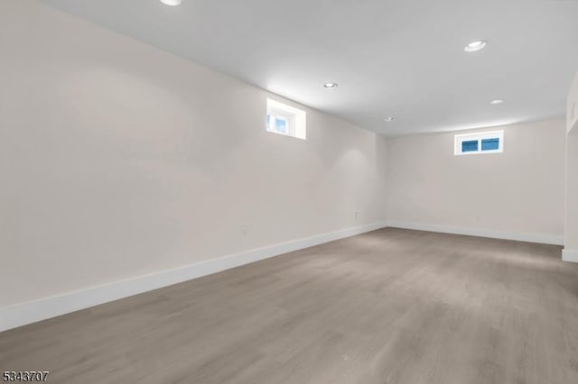 basement featuring recessed lighting, baseboards, and light wood finished floors