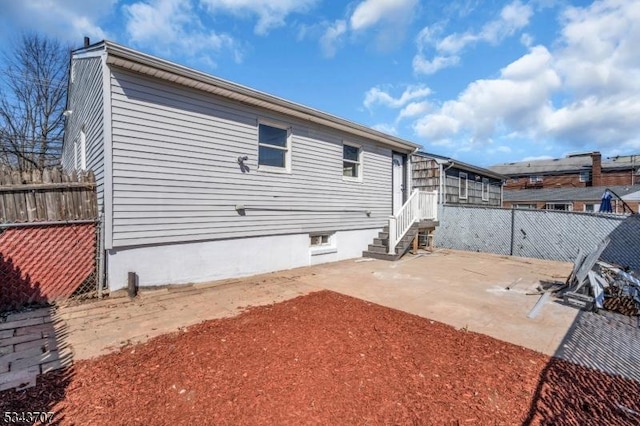 back of property featuring a patio area and fence