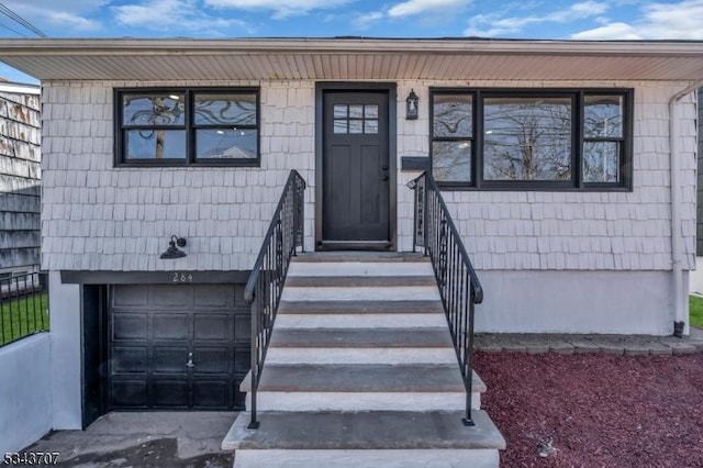 property entrance featuring an attached garage