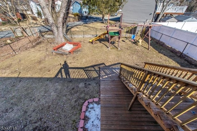 view of yard featuring a playground and fence