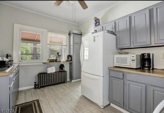 kitchen featuring white appliances, radiator, gray cabinets, and ceiling fan