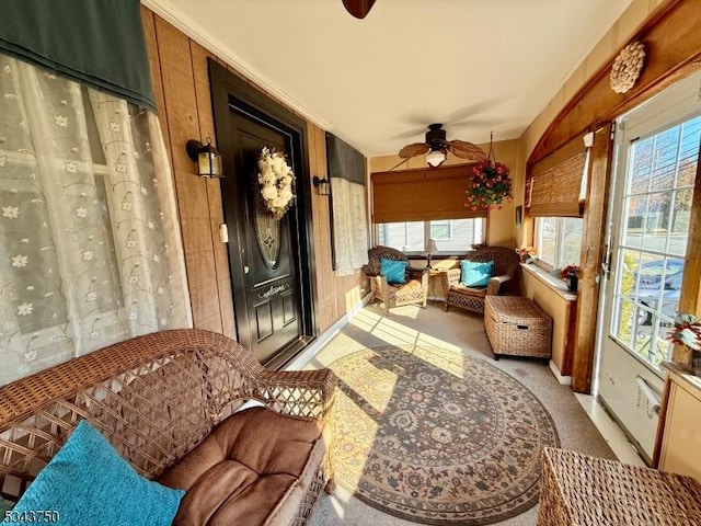 sunroom / solarium with a ceiling fan