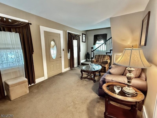 living room featuring stairway, carpet, and baseboards