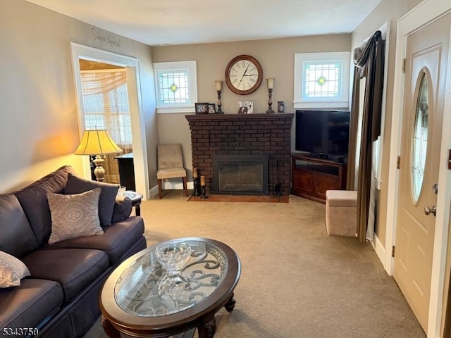 living room with a brick fireplace, carpet, and a wealth of natural light