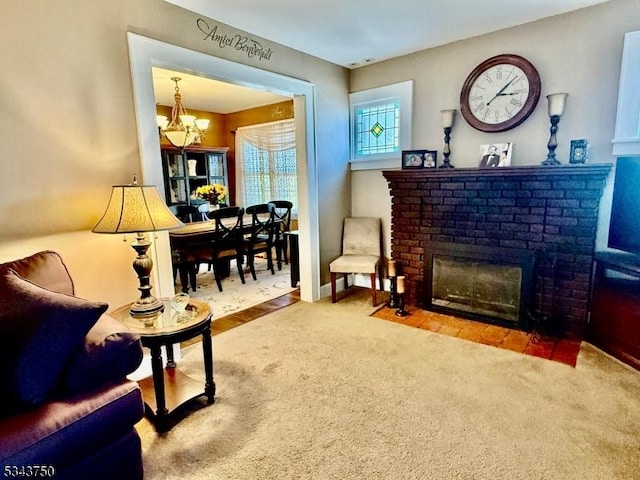 living room with a fireplace, an inviting chandelier, and carpet floors