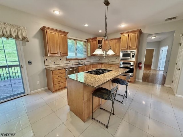 20 Tonnelier Way, Denville Twp, NJ 07834 - kitchen featuring appliances with stainless steel finishes, a breakfast bar, decorative backsplash, light stone countertops, and recessed lighting