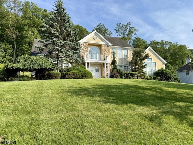 20 Tonnelier Way, Denville Twp, NJ 07834 - view of front facade featuring a front yard, a balcony, and stone siding