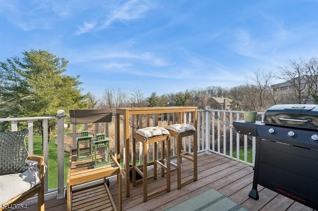 wooden deck featuring a grill