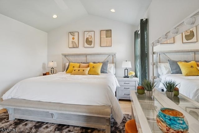 bedroom with recessed lighting, lofted ceiling, and wood finished floors