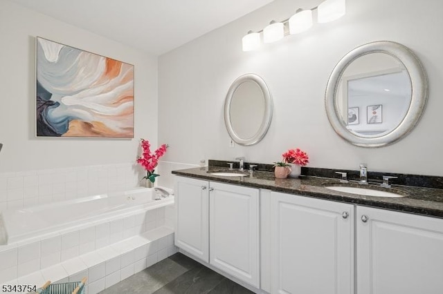 full bathroom featuring a garden tub, double vanity, and a sink