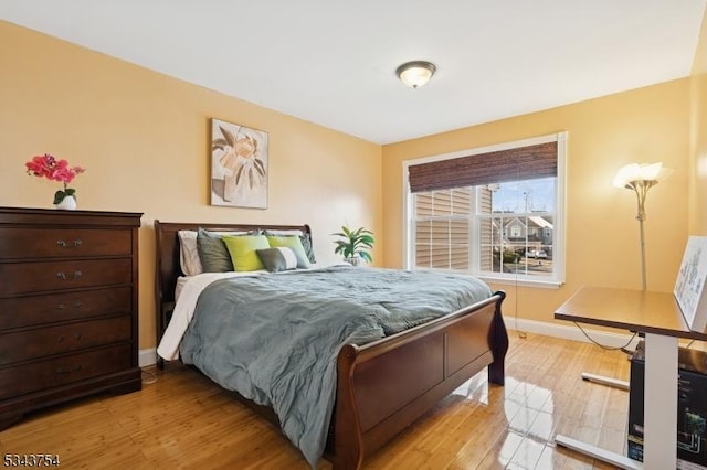 bedroom featuring light wood-type flooring and baseboards