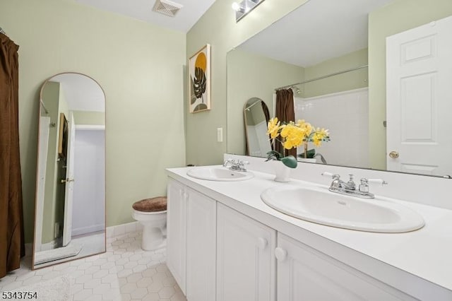 full bath featuring tile patterned flooring, toilet, visible vents, and a sink