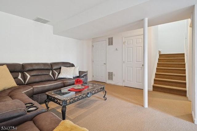 carpeted living area with visible vents, stairs, and baseboards