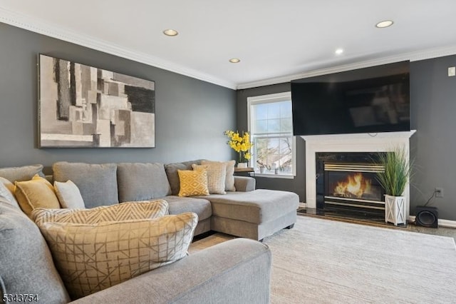 living room featuring recessed lighting, a fireplace, baseboards, and ornamental molding