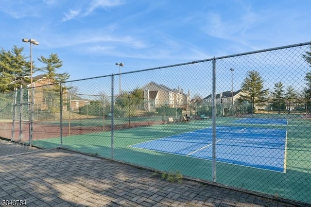 view of sport court featuring fence