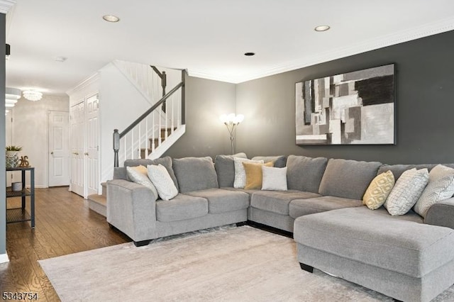 living room featuring stairs, crown molding, recessed lighting, and wood finished floors