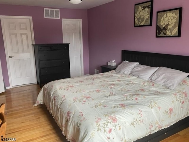 bedroom featuring visible vents and light wood-style floors