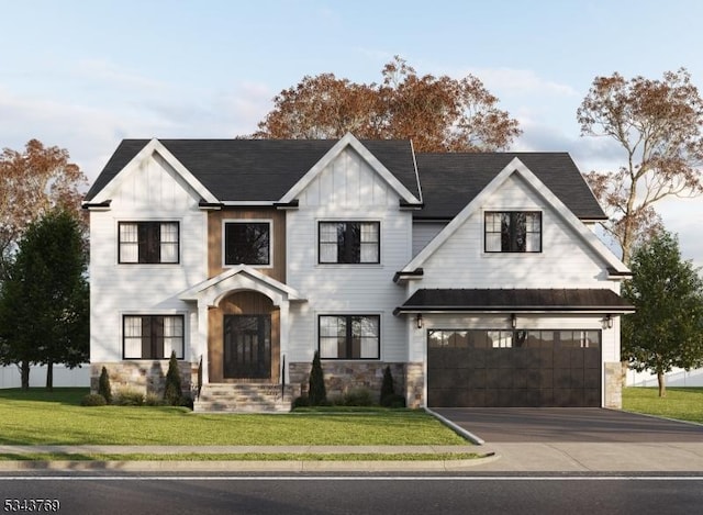 view of front of house featuring a front yard, a garage, stone siding, aphalt driveway, and board and batten siding