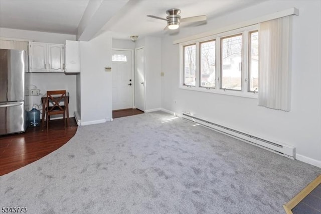 unfurnished living room featuring a baseboard heating unit, baseboards, ceiling fan, dark wood-style floors, and dark colored carpet