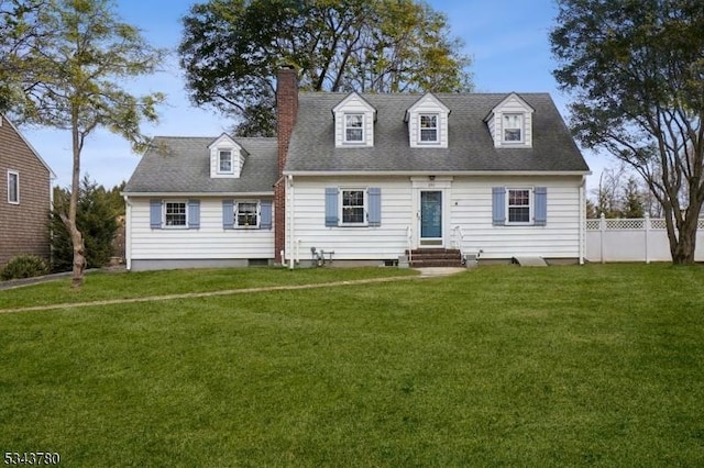 cape cod house with entry steps, a front lawn, fence, and a chimney