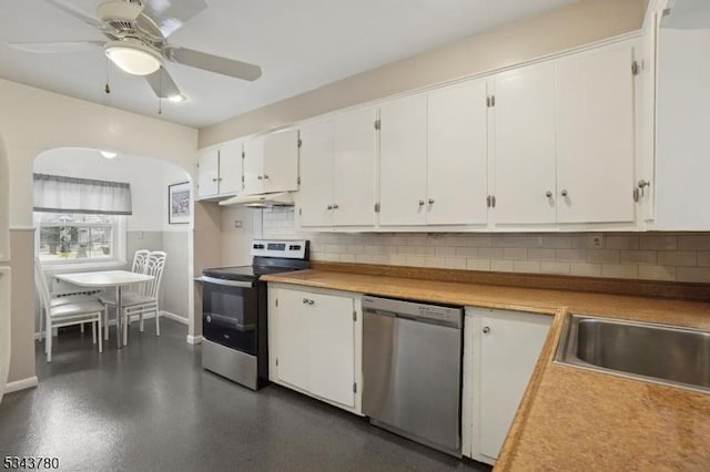 kitchen featuring ceiling fan, stainless steel appliances, backsplash, and white cabinets