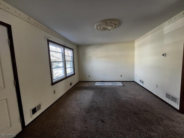 spare room with visible vents, carpet flooring, and crown molding