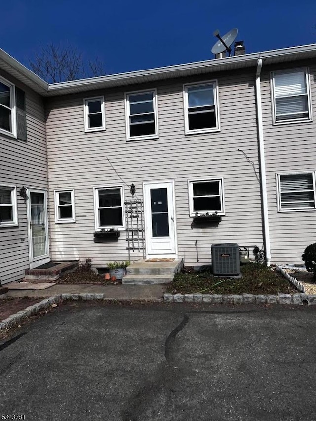 view of front of property with cooling unit and entry steps