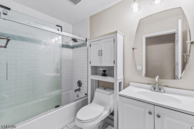 full bath with visible vents, vanity, toilet, and shower / bath combination with glass door