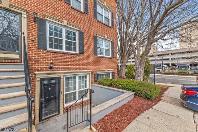 view of exterior entry featuring brick siding