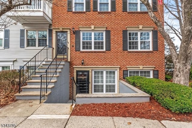 entrance to property featuring brick siding