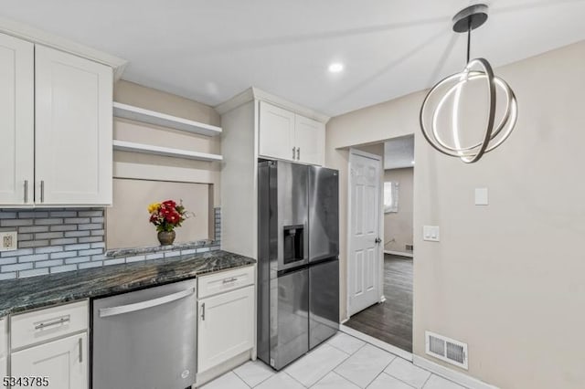 kitchen with fridge with ice dispenser, visible vents, tasteful backsplash, stainless steel dishwasher, and white cabinets