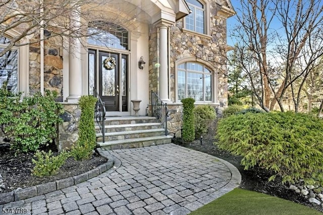 entrance to property featuring stone siding