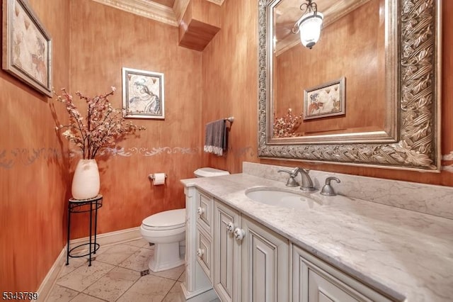 bathroom featuring vanity, toilet, and baseboards