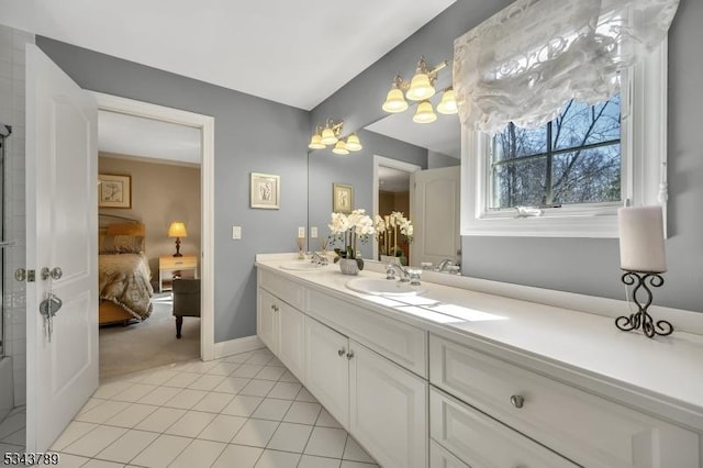 ensuite bathroom with a sink, ensuite bath, double vanity, and tile patterned flooring