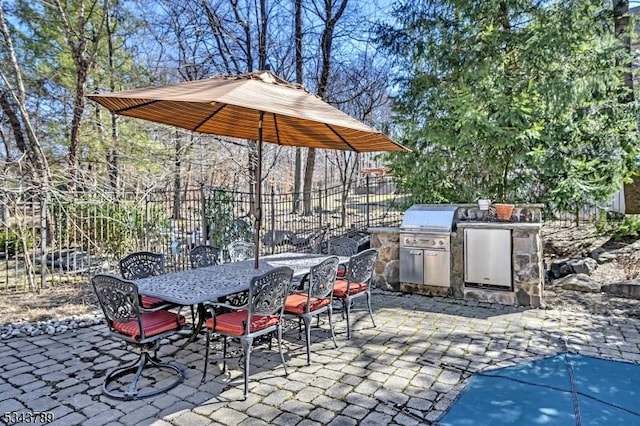 view of patio / terrace with outdoor dining space, exterior kitchen, and fence