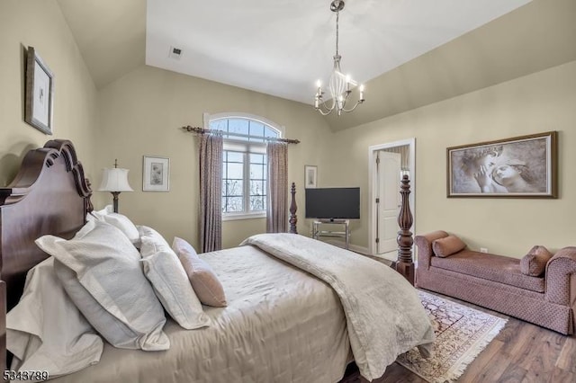 bedroom with visible vents, wood finished floors, an inviting chandelier, and vaulted ceiling