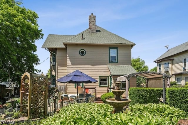 7 High St, Stanhope Boro, NJ 07874 - back of property with a pergola, a chimney, and roof with shingles