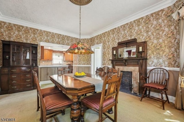 7 High St, Stanhope Boro, NJ 07874 - dining room featuring wallpapered walls, light colored carpet, ornamental molding, a wainscoted wall, and a high end fireplace