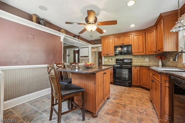 7 High St, Stanhope Boro, NJ 07874 - kitchen with black appliances, a sink, brown cabinetry, a ceiling fan, and wainscoting